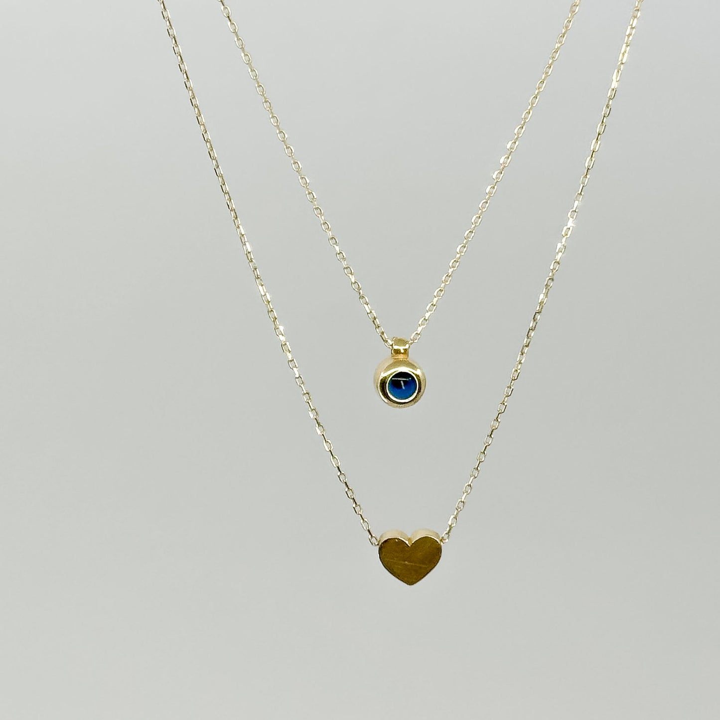 Collar Doble Corazón y Ojo Turco de Oro 18K