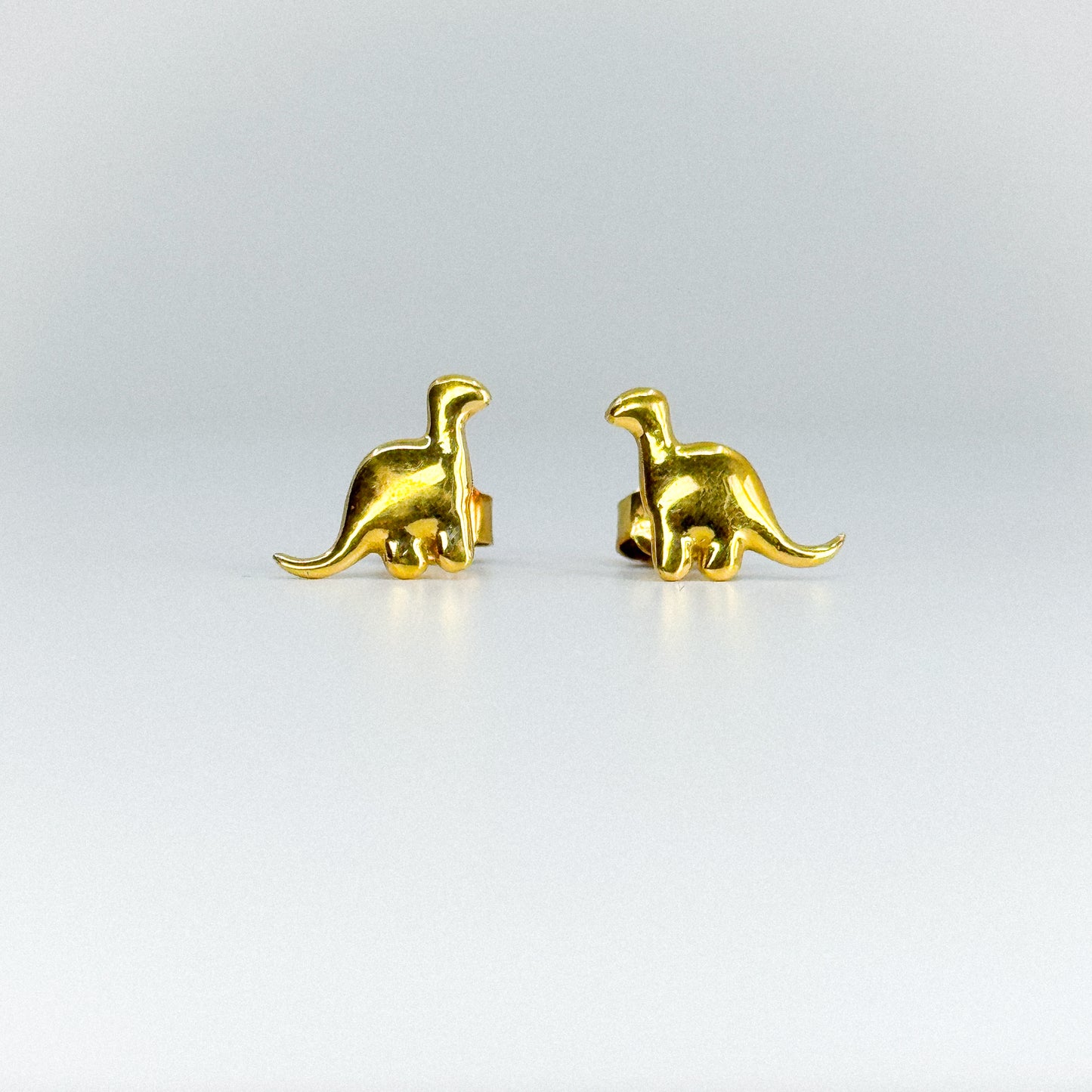 Aretes dinosaurio en oro 18k