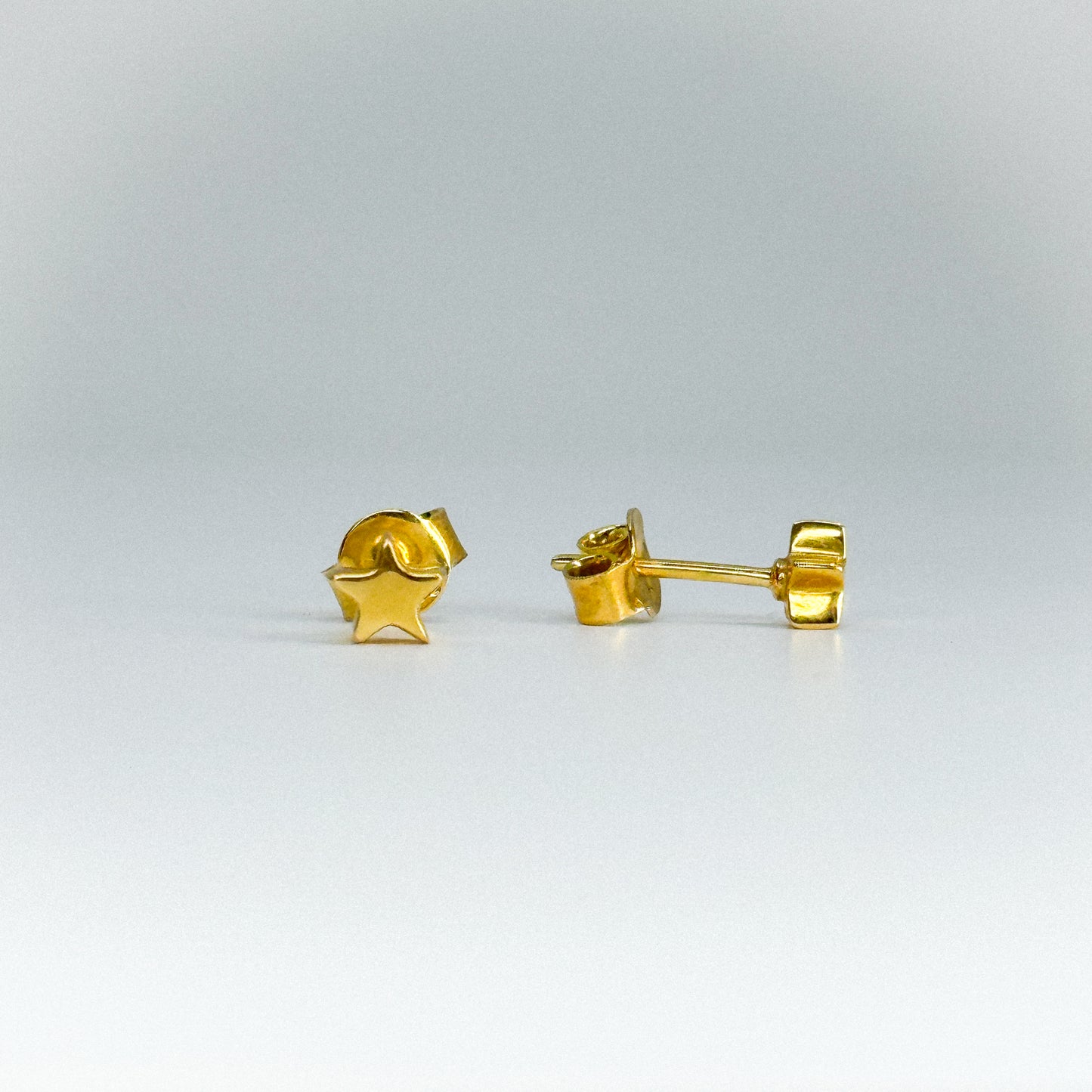 Aretes estrella en oro 18k